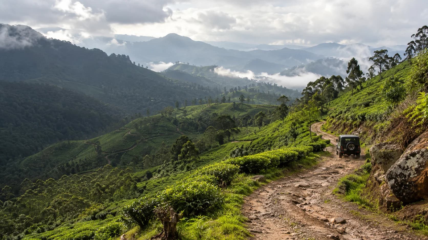 Jeep travelling along a winding road in the misty Sri Lankan highlands