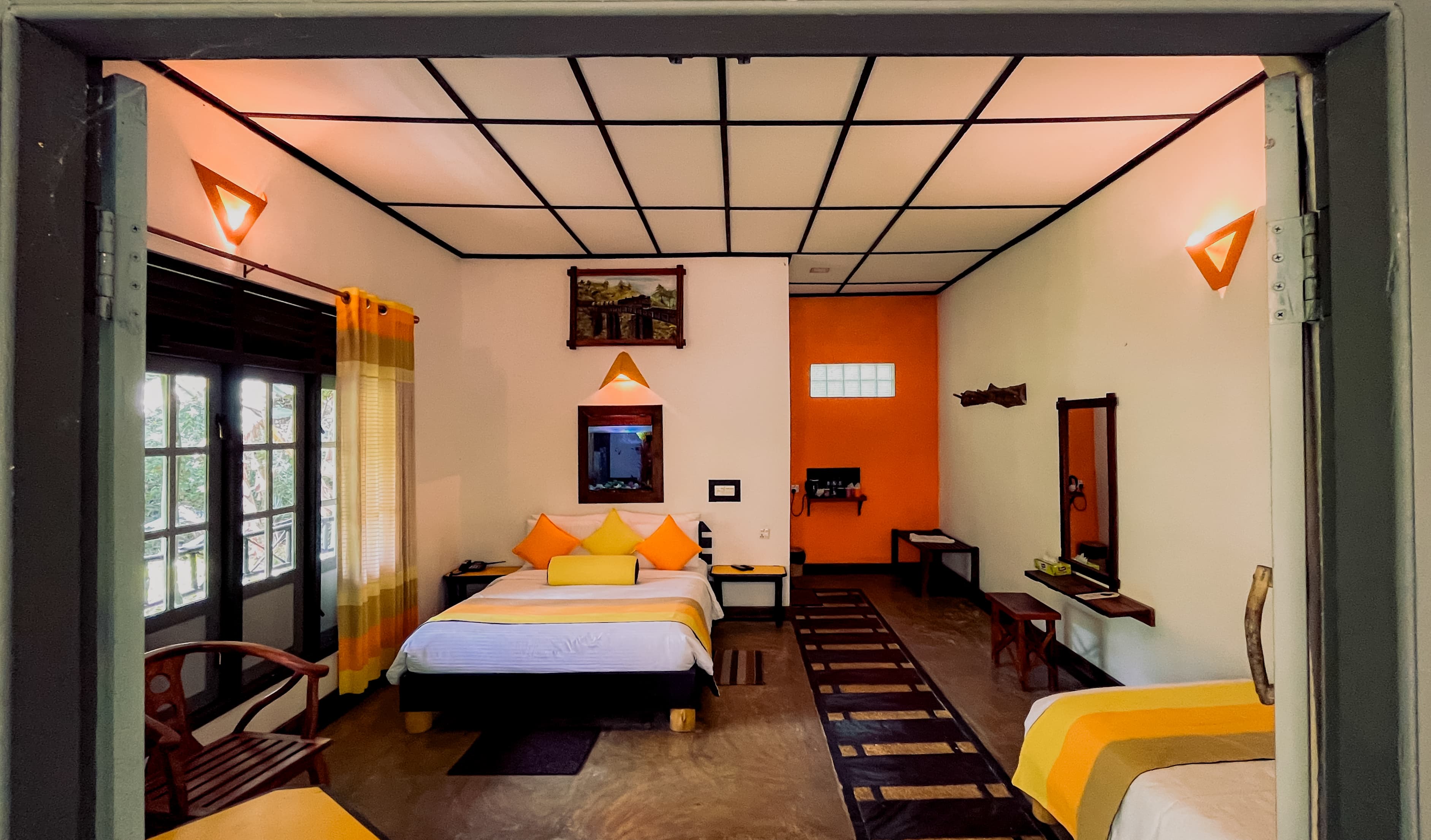 Warm and spacious guest room with yellow accents at Train View Chalet