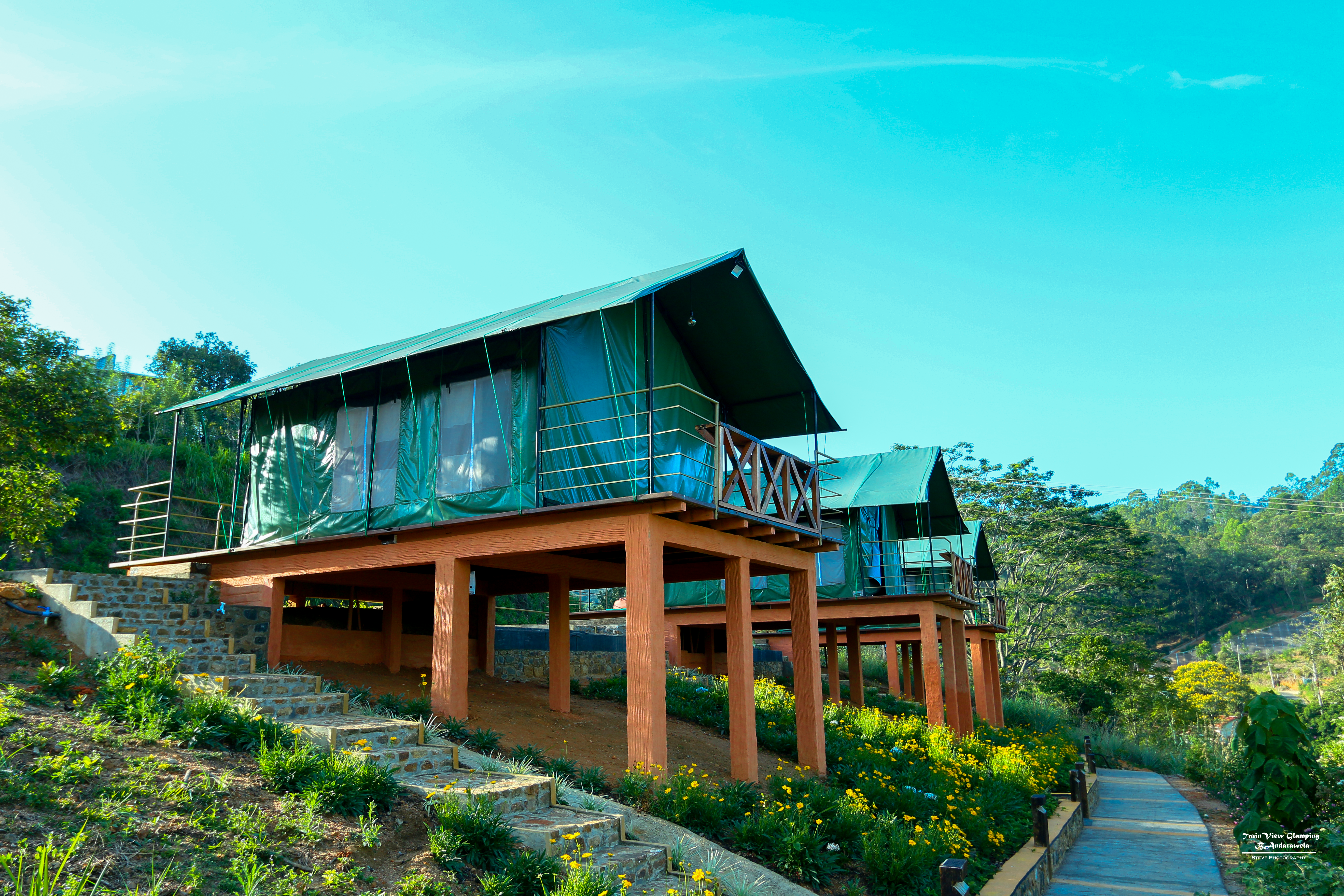 Elevated glamping tents surrounded by flowers