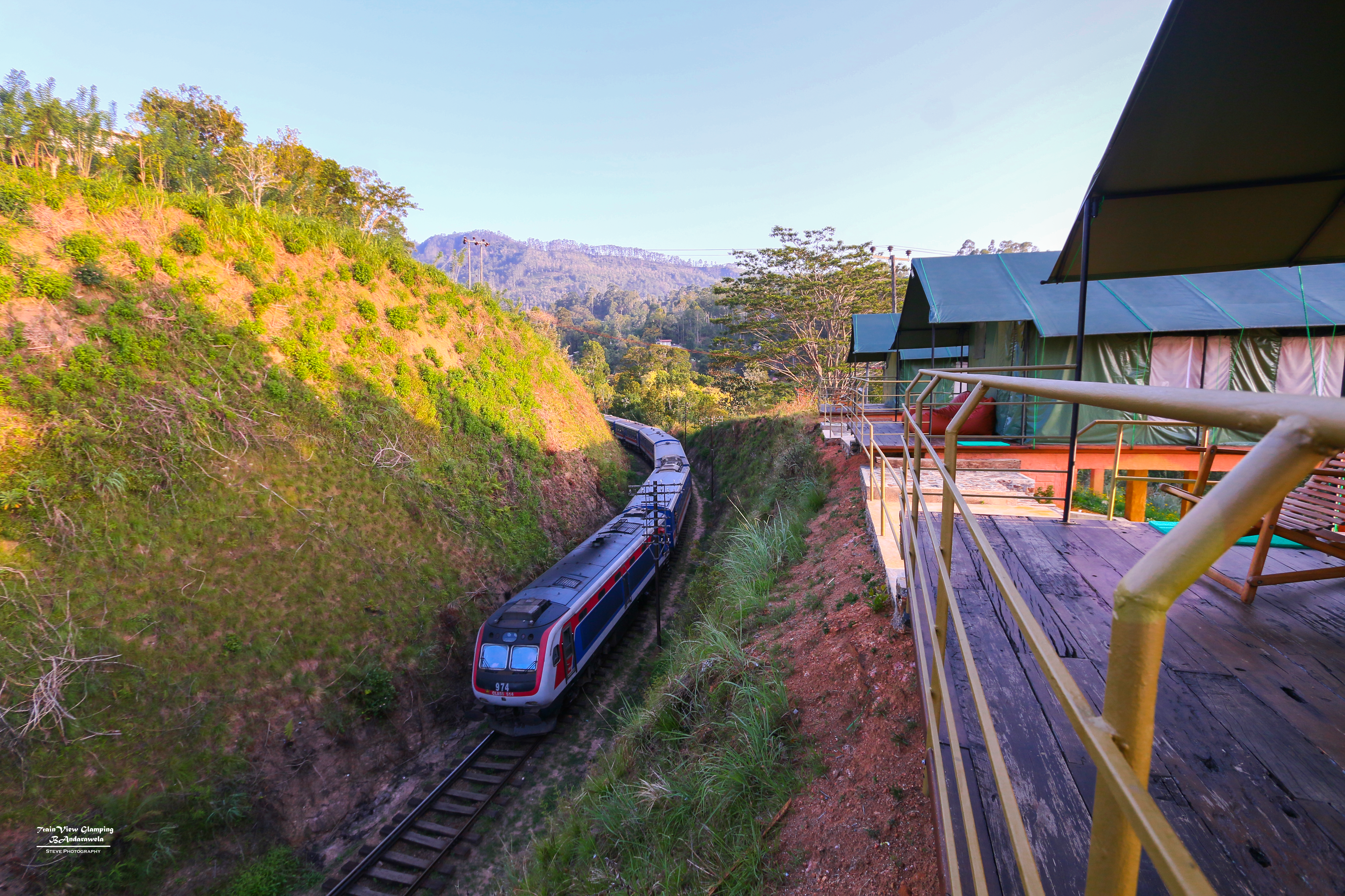 Train passing directly below the glamping deck