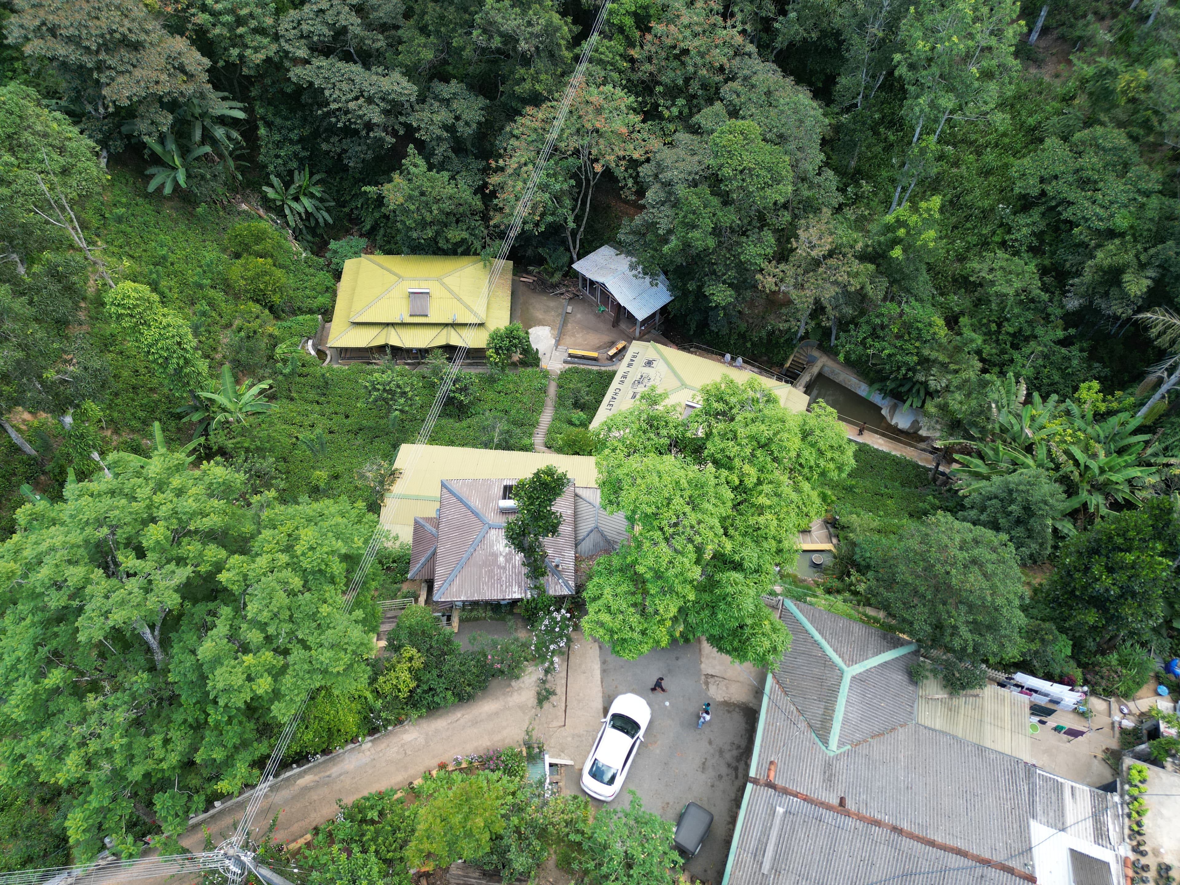 Aerial view of Train View Chalet among dense green hills